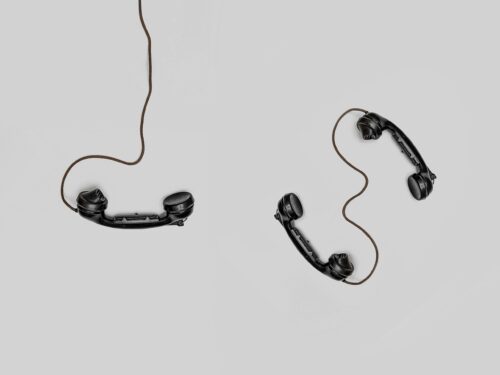 three telephones connected with wires for communication